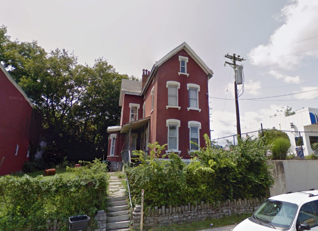 975 Elberon Avenue - brick three-story single-family home.