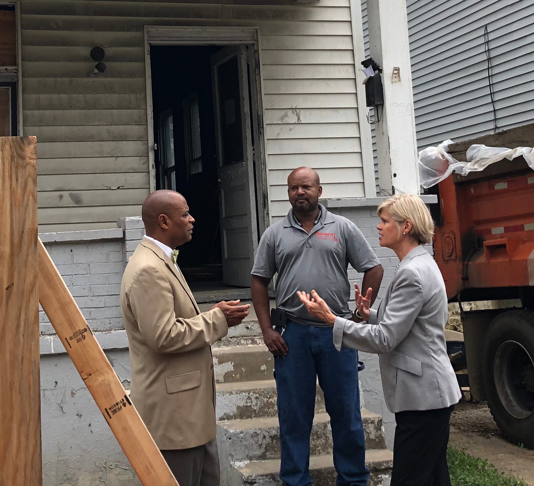 Cropped - Laura, Eric and Robert The HURC is rehabbing six vacant, severely blighted, single-family homes in Evanston, creating homeownership opportunities for low- to moderate-income individuals and families. Robert Killins, Jr., Director of Special Initiatives at the Greater Cincinnati Foundation, which provided a $1,000,000 impact investment to The Port for the rehab of foreclosed, vacant residential properties into homes ready for sale, and Laura Brunner, President and CEO of The Port, talk with Eric Hunn, Hunn's Construction, who is rehabbing 1650 Jonathan for the HURC.
