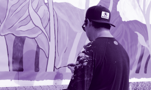 Local artist painting a mural at the Groundbreaking for The Artistry Cincinnati