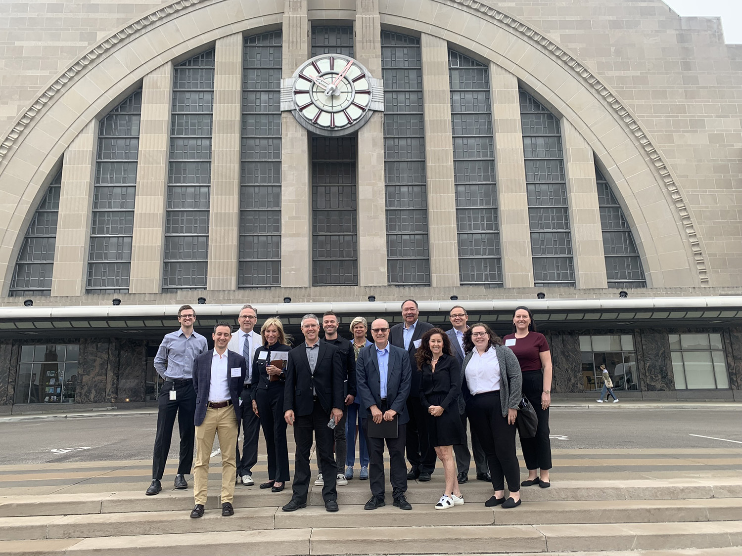 Group of roughly a dozen people in front of Cincinnati's Union Terminal Building.